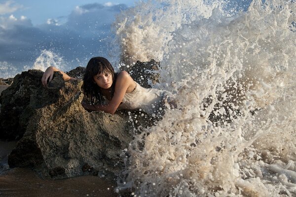Girl on the background of splashing waves