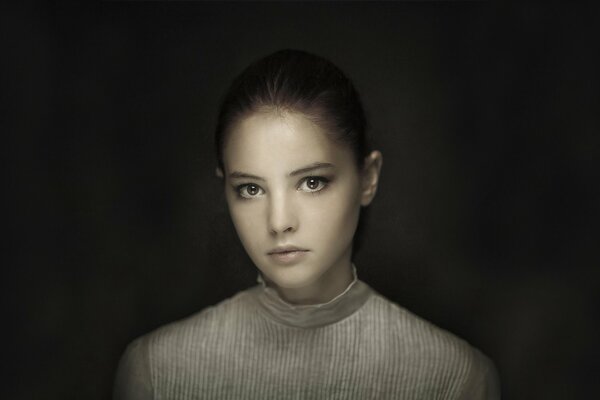 Portrait of a brown-eyed girl on a dark background