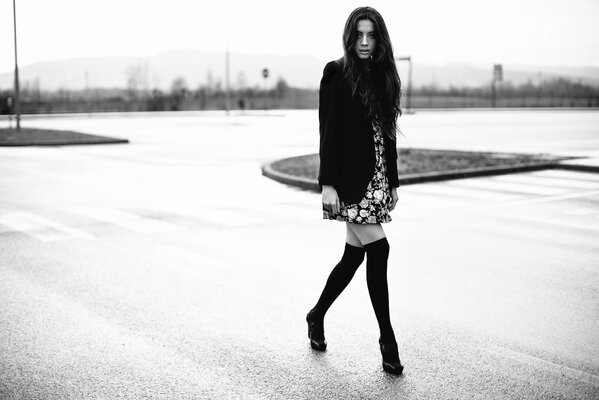 Brunette girl in long boots and coat