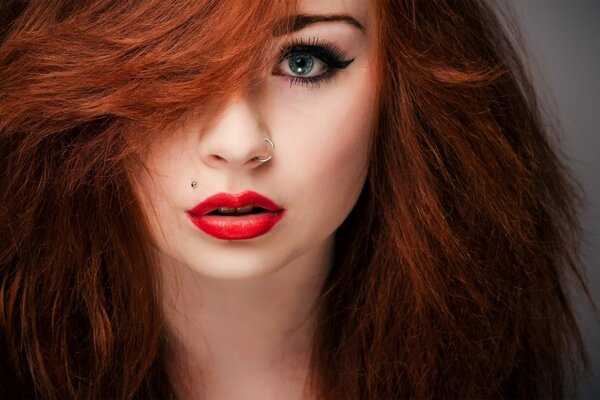 Beautiful redhead girl with red lips