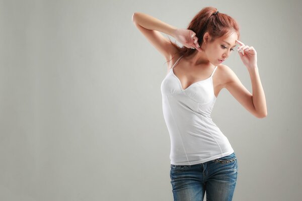 Red-haired girl in a T-shirt and jeans