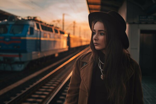 The girl in the black hat at the railway station