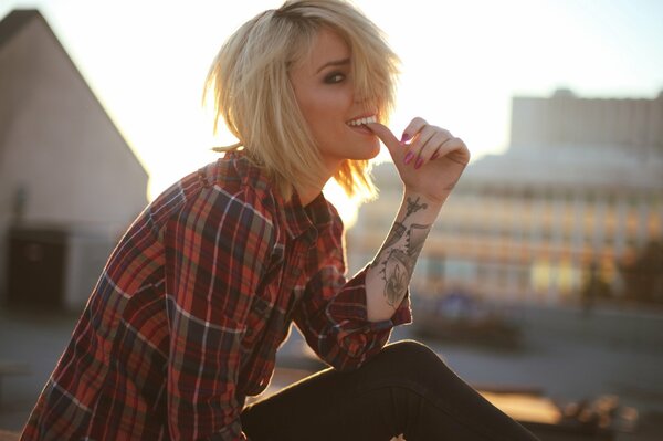 A model girl in a shirt and with a tattoo