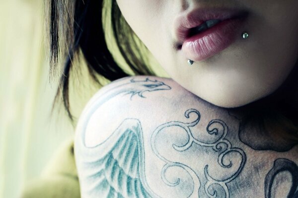 Fille avec piercing et tatouage