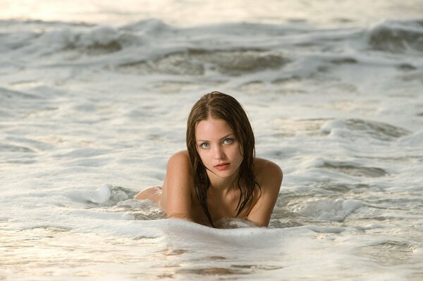 Sexy photo of a brown-haired girl in the water