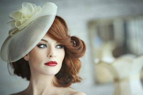 Beautiful girl with red hair in a hat