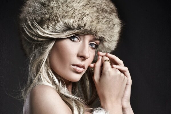 A model poses in a fur hat