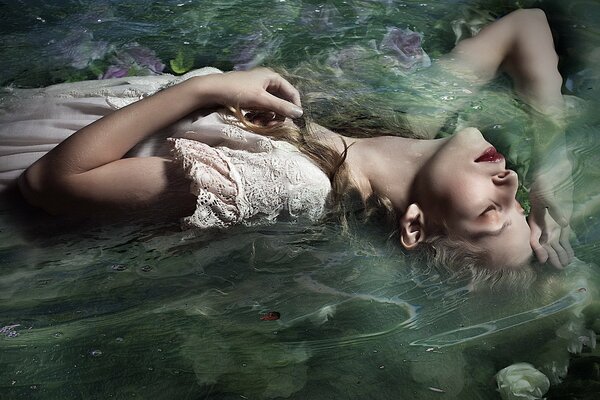 Girl with long hair in the water