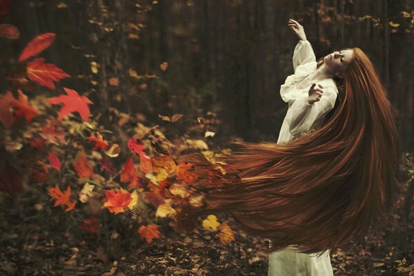 A red-haired girl and an autumn whirlwind of leaves