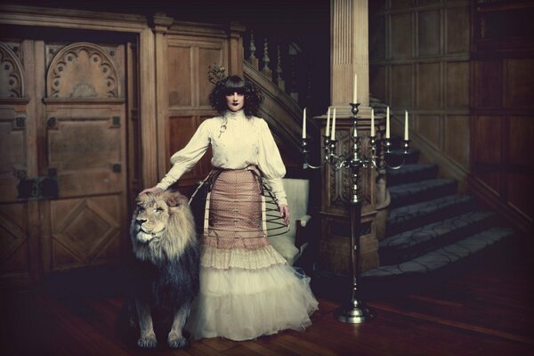 A girl with a lion near the steps and a candlestick