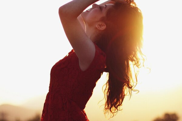 Joyful girl posing at sunset