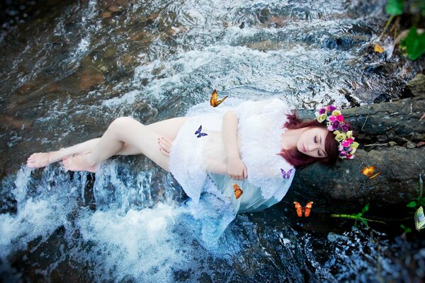 Girl with butterflies by the river