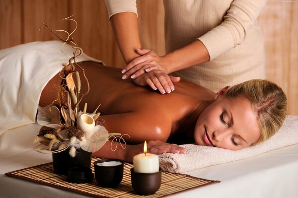 A girl on a massage procedure in a spa salon