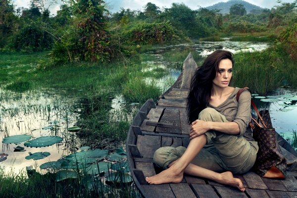 Anddelina Jolie in a boat in the swamp