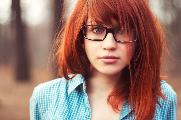 A red-haired girl in glasses and a shirt