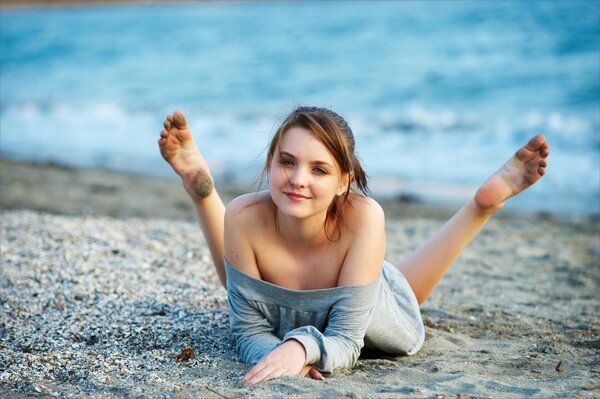 Beautiful girl lying on the beach