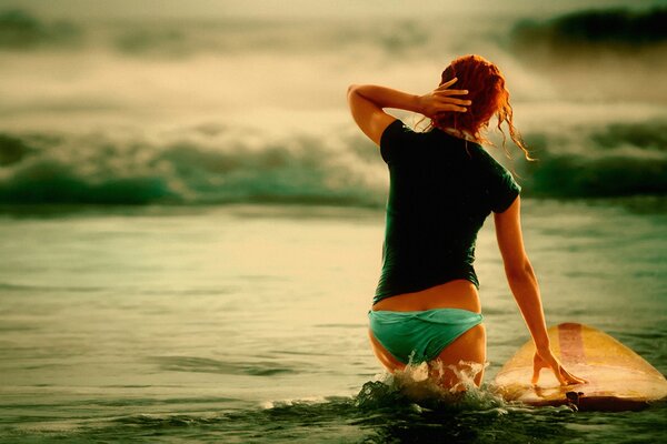 Surfer at sunset in the ocean