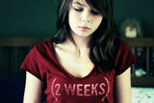 Sad girl in a red T-shirt