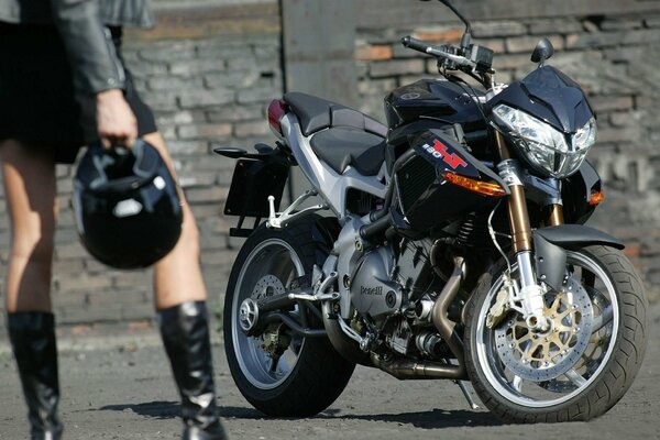 Women s legs on the background of a sport bike