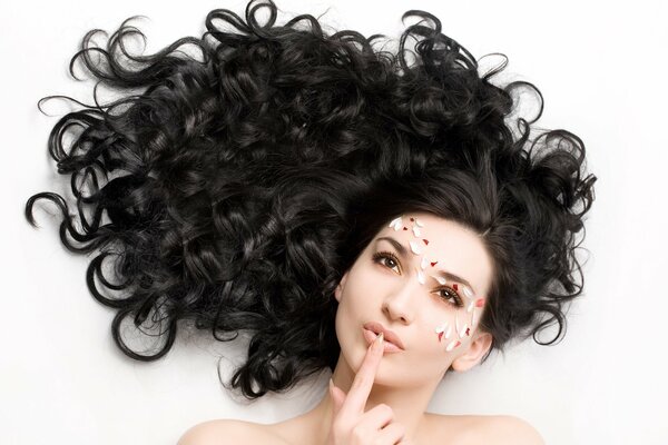 A girl with dark hair on a white background