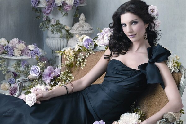 Beautiful girl surrounded by roses