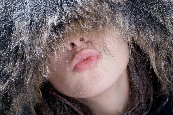 A girl in a fur hat with frost