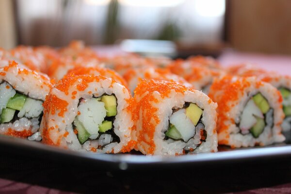 Rolls with avocado and caviar on a plate