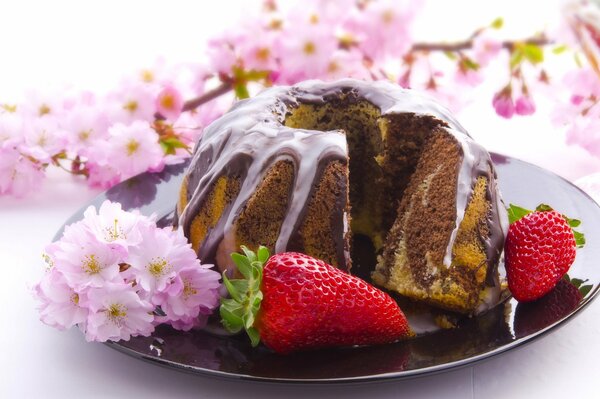 Cupcake de chocolate con fresa y rama de jazmín rosa