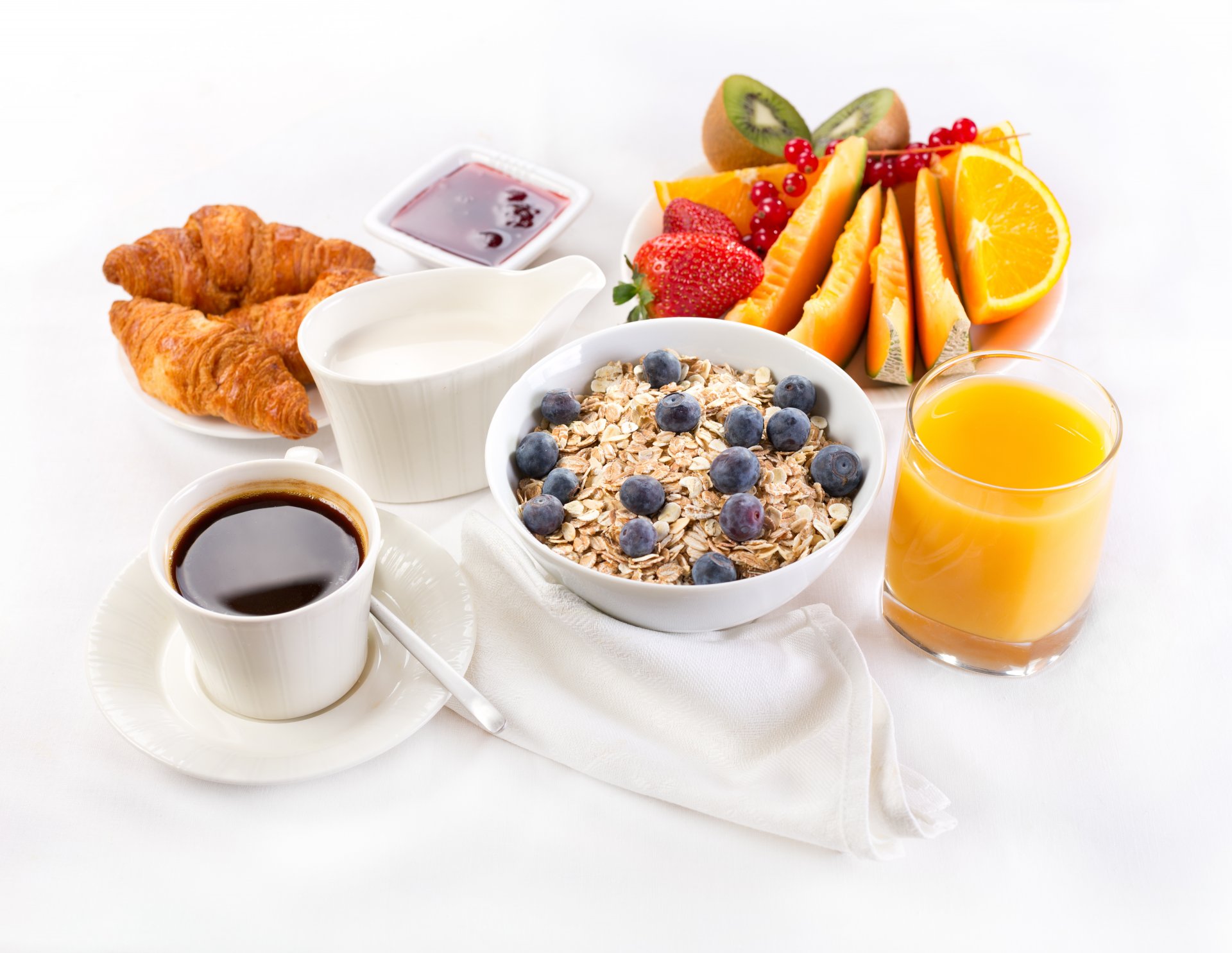 breakfast coffee fruits juice serving oatmeal croissants jam cream