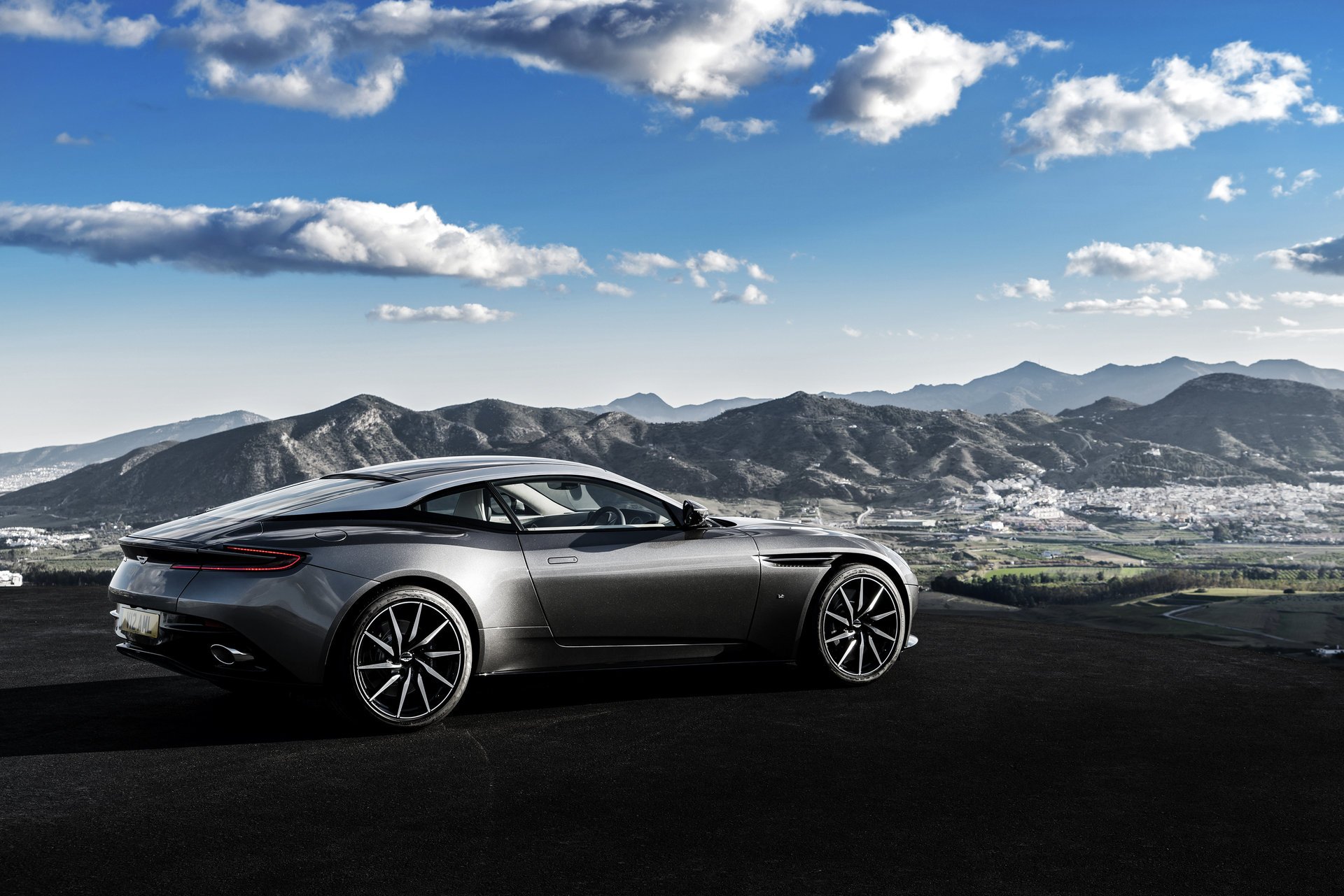 parking aston martin supercar photo mountains town