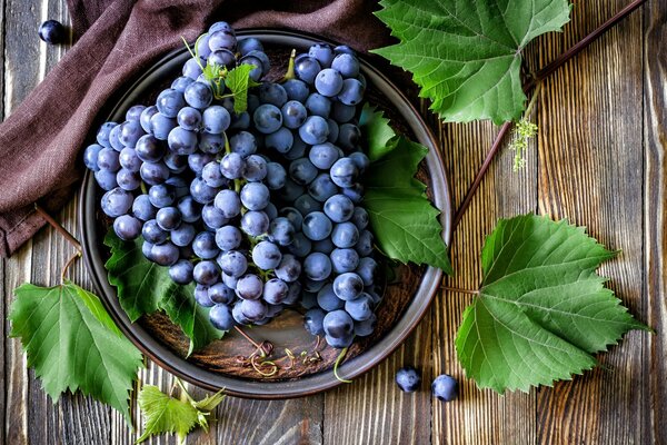 Fragrant grapes on ceramic dishes