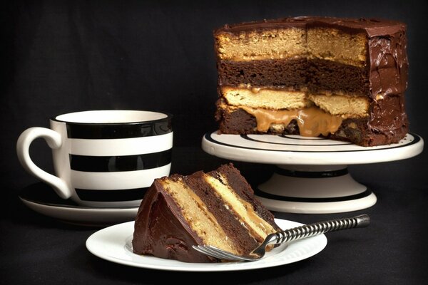 Tea party with a cake on a black background