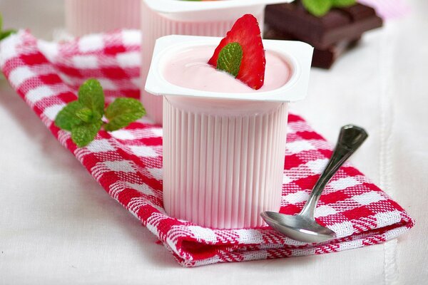 Strawberry yogurt in a cup decorated with mint