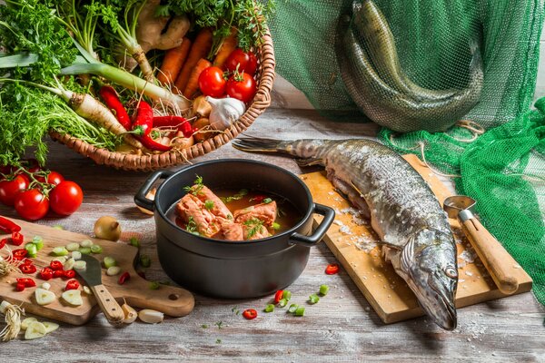 Table during the preparation of bright fish soup