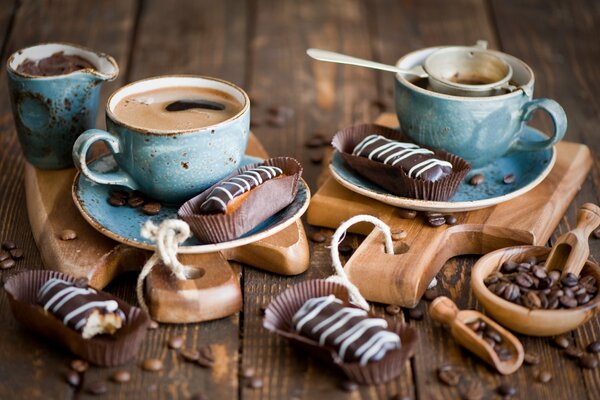 Two cups of coffee beans and cakes