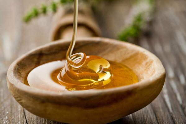 A bowl on the table with honey filling. Professional shooting