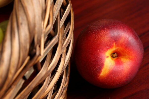 Nectarine in a basket on the table