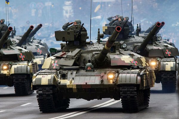 Military tanks with military personnel on parade