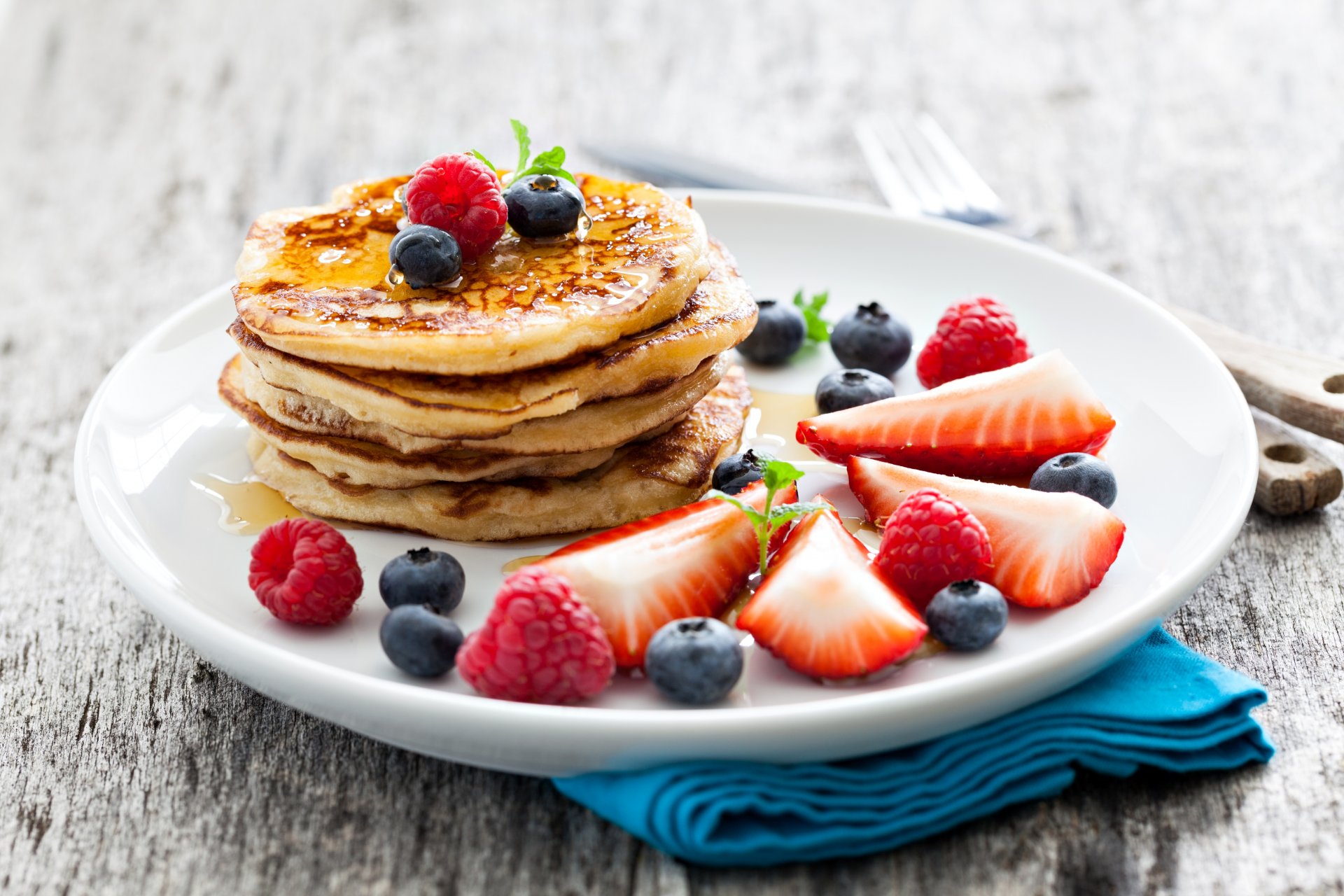 pancakes pancakes fritters plate berries blueberries raspberries strawberries honey food