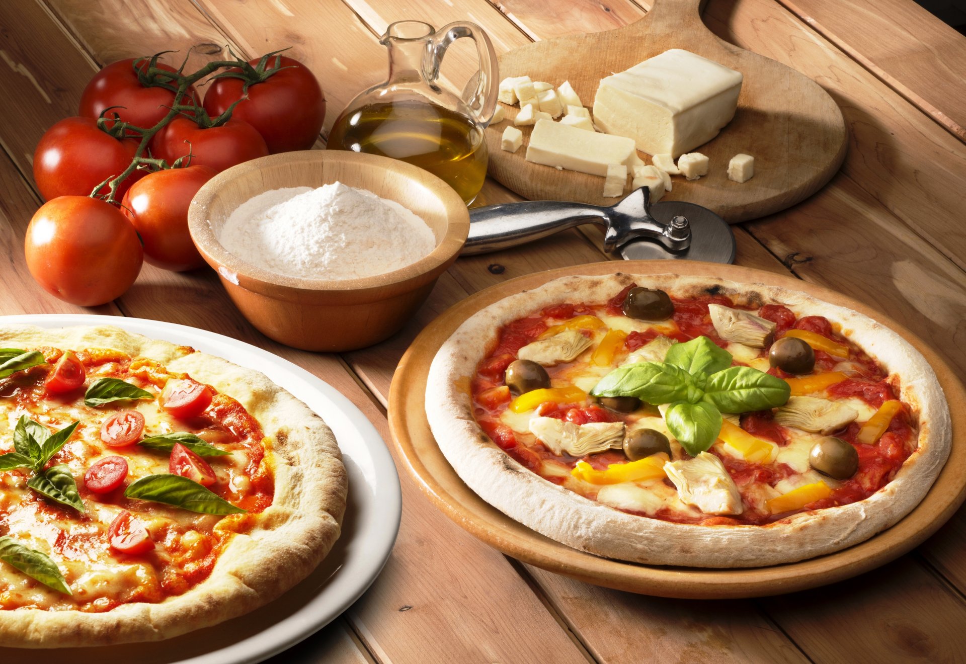 pizza food chicken olives cheese pepper flour tomatoes oil board table