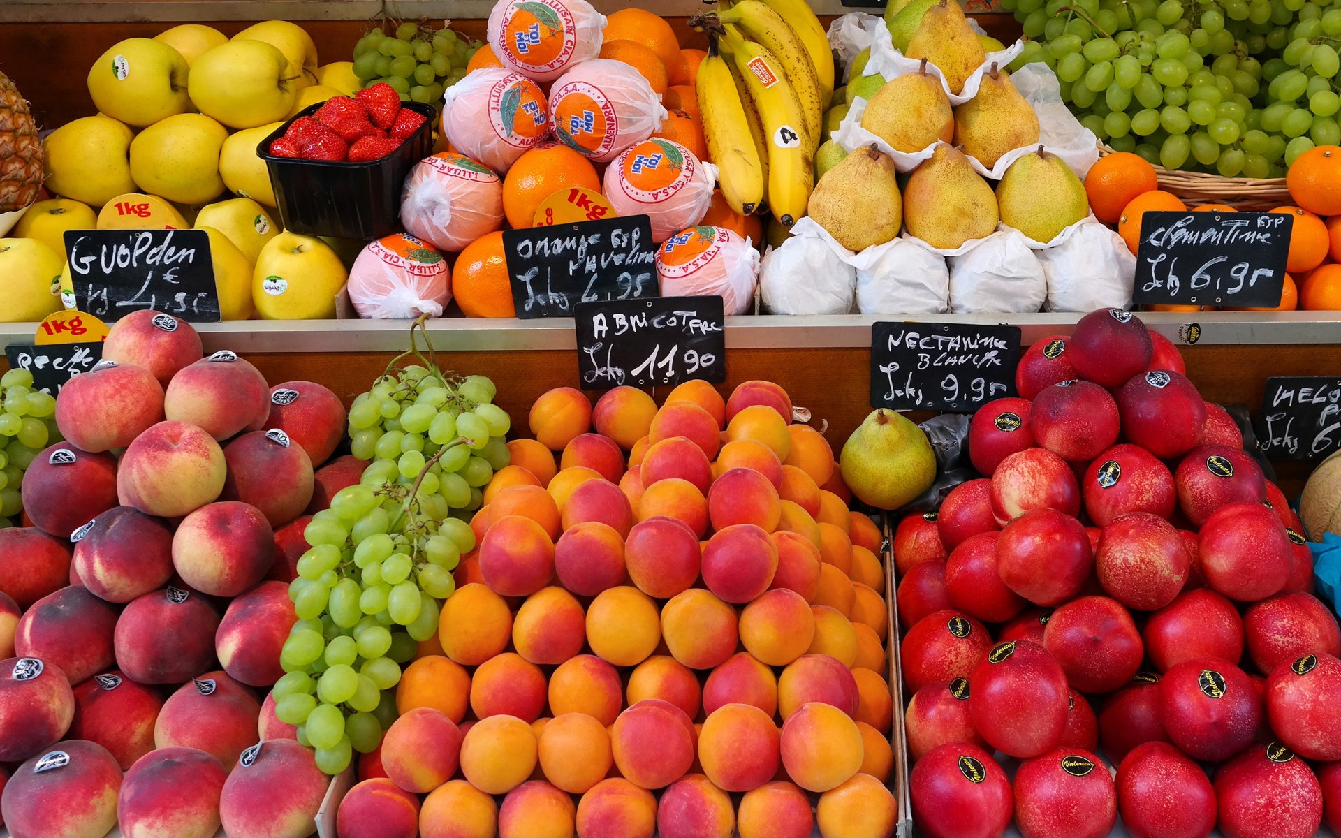 food fruit street market bazarchik counter windows tags peaches apricots nectarines pear grapes orange mandarins bananas strawberry apples fresh fruits round year is main condition to maintain health wallpaper