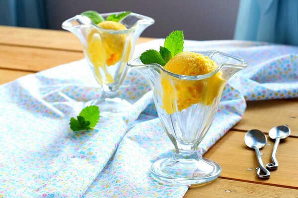 Yellow ice cream in cremans on the table