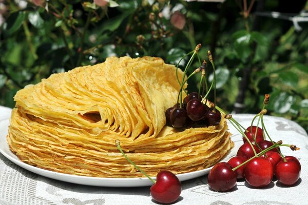 Breakfast in the garden, pancakes with cherries and cherries