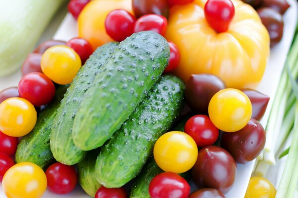 Colorful multicolored Cherry tomatoes and cucumbers