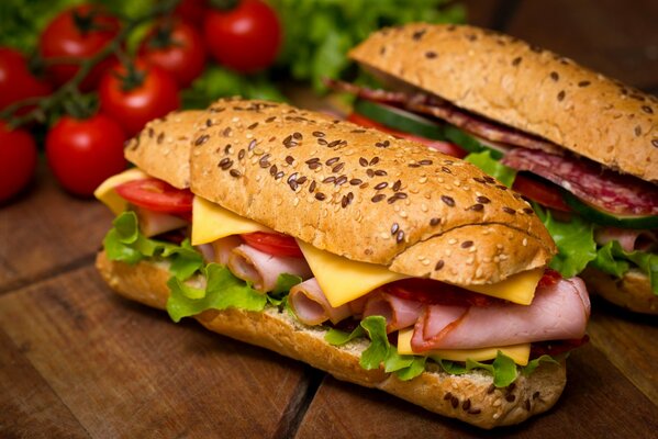 Two sandwiches with ham and cherry tomatoes