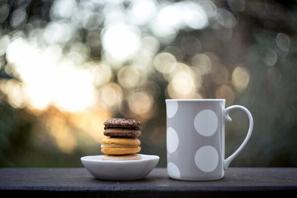 Grey mug in white peas with cookies