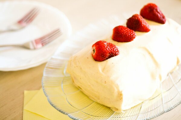 Ice cream with strawberries on a transparent plate