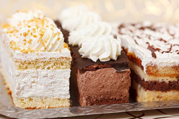 Three cakes on the table with air cream