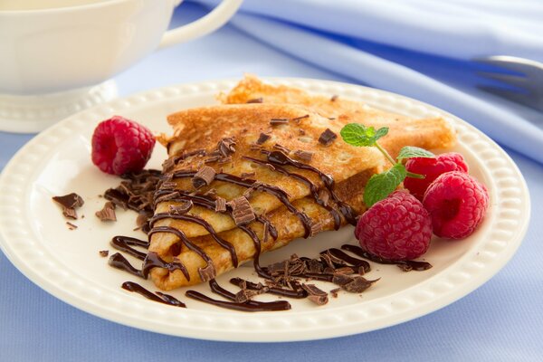 Pancakes with chocolate topping with berries