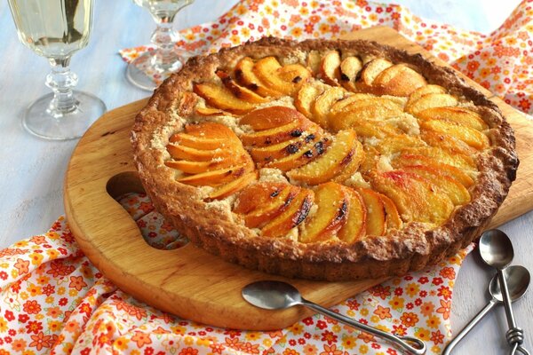 Kuchen mit Pfirsichen auf einem Holzbrett